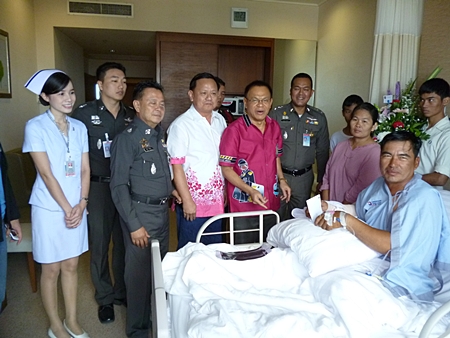 Region 2 Police commander Lt. Gen. Punya Maamen and top Banglamung Station officers visit Prasit Boonserm in hospital.